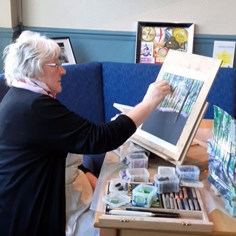 Phillip Jeffrey class 2 (002) Senior painting a picture on easel